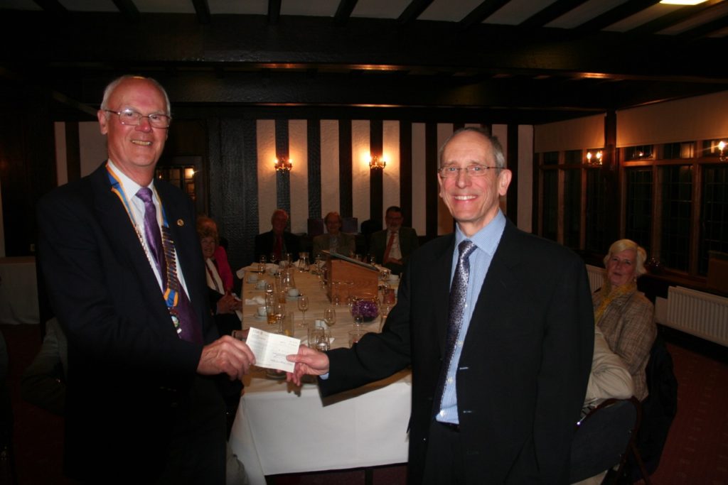 Photo, above: Long-term supporter, Malcolm Rolfe, receiving a cheque on behalf of Anglof Regional Foundation & Humanitarian Relief Agency (ARFHRA) from the President of The Rotary Club of Hagley, Martin Freckleton, June 2015. Top: A visit to the enormous statue of San Carlo Borromeo at Arona was one of the highlights of Malcolm Rolfe’s visit to the Italian lakes, organised by Riviera Travel who donated 10% of the cost of the holiday to Anglof Regional Foundation & Humanitarian Relief Agency (ARFHRA).