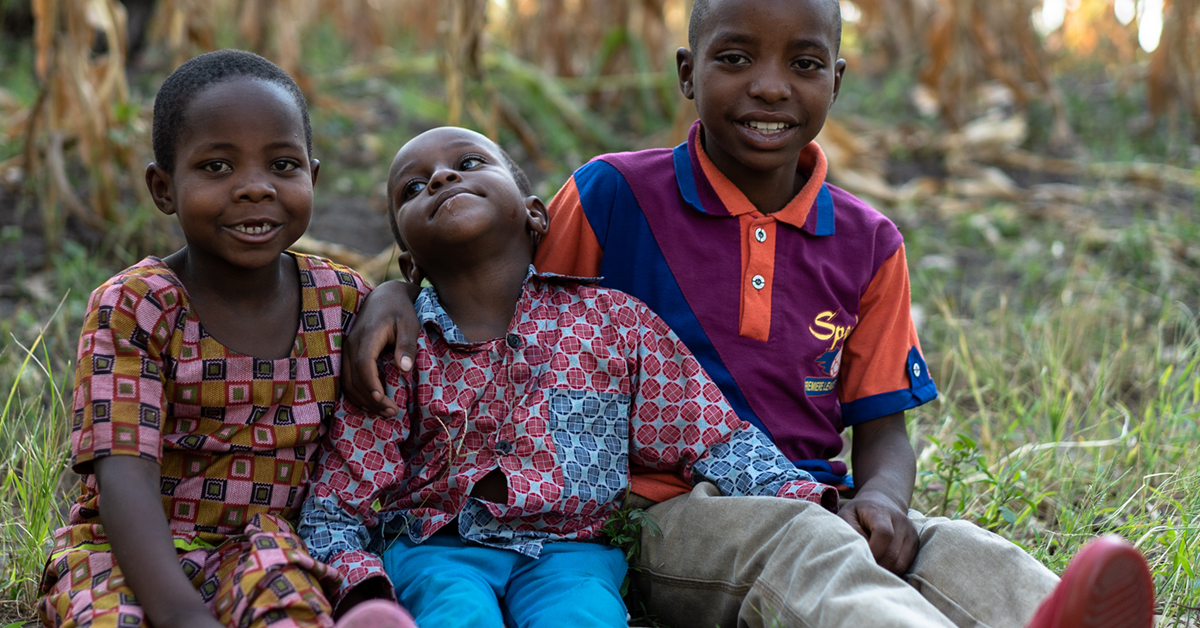 Carrol sittingwith his siblings, Rwanda