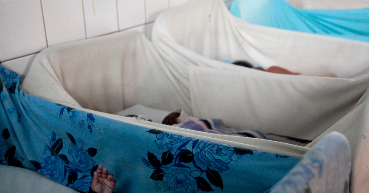Cots lined up in a row in an orphanage