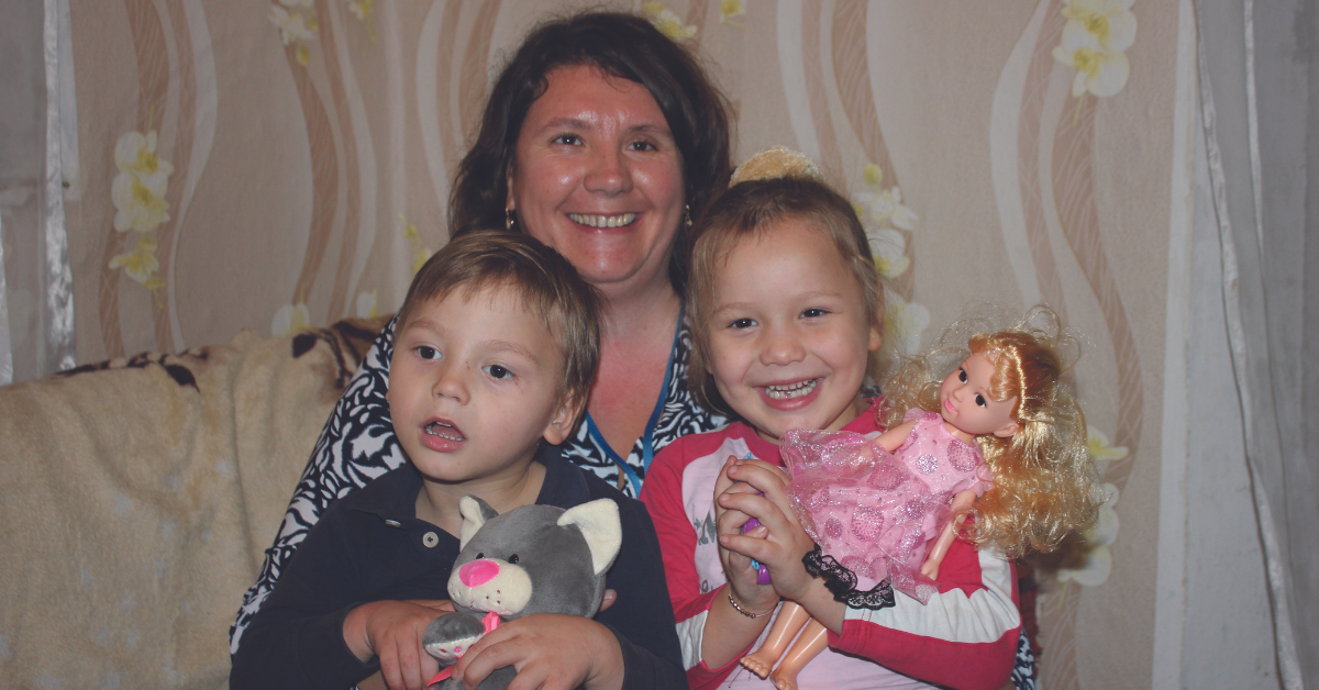 Vasilică and Ecaterina love to play with social worker Natalia (middle)