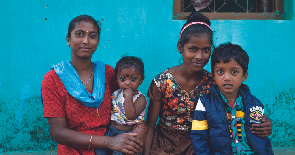 Jacinta, one of the children we helped in India, with her family.