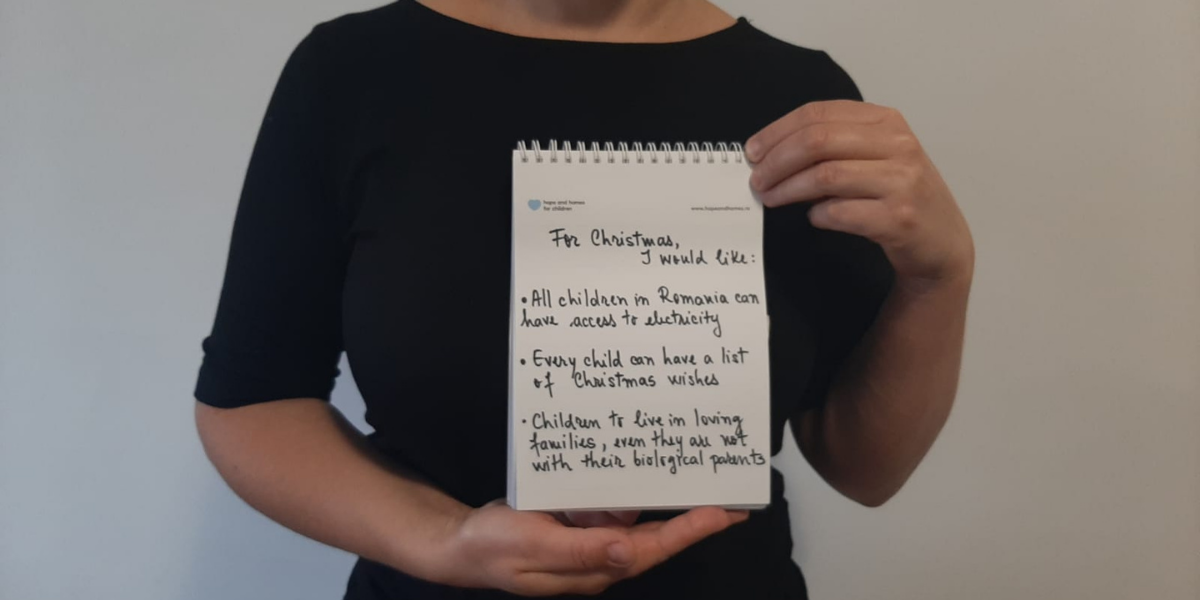 A social worker holding up their Christmas List
