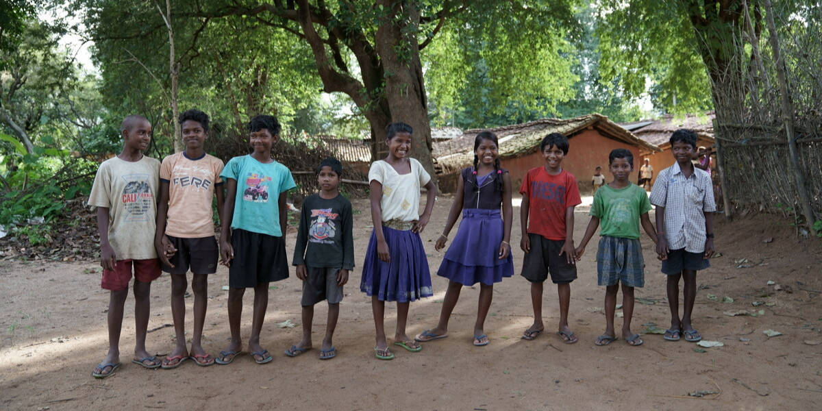 Sonia (centre) standing with her friends. Sonia is one of the children we have helped in India.